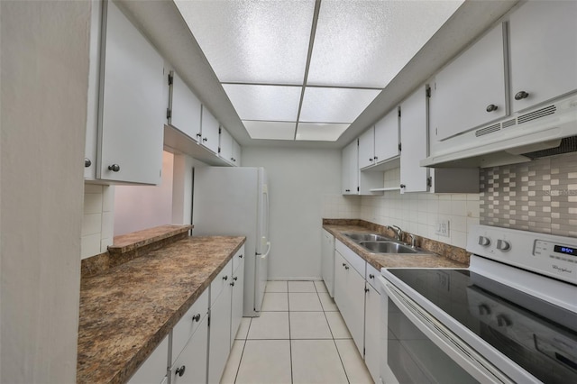 kitchen featuring white cabinetry, electric range, sink, backsplash, and light tile patterned floors