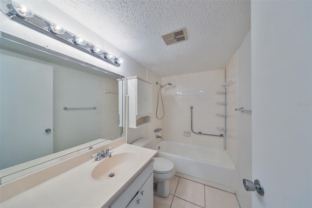 full bathroom featuring tile patterned floors, a textured ceiling, toilet, vanity, and tiled shower / bath