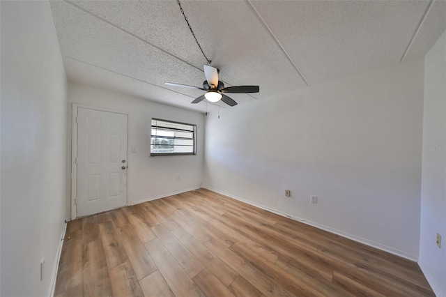 spare room with ceiling fan and hardwood / wood-style flooring