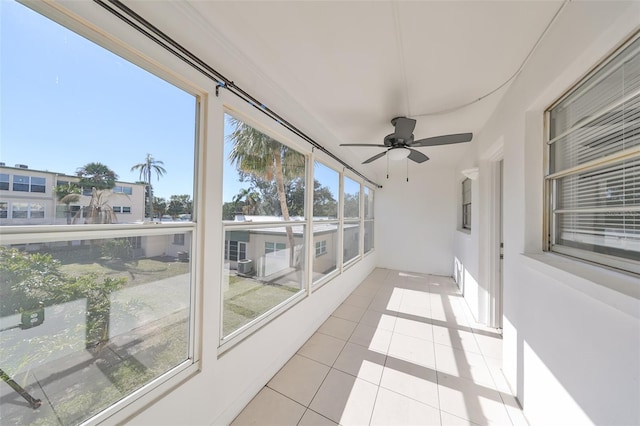 sunroom featuring ceiling fan