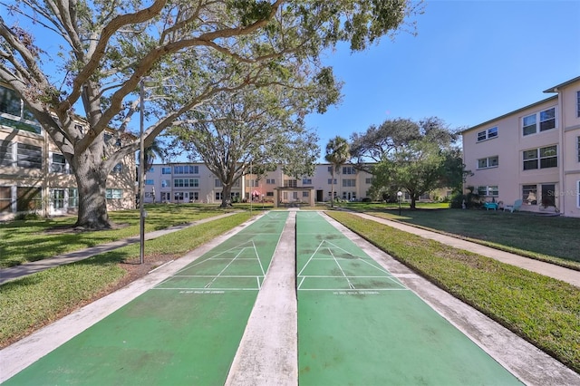 view of property's community featuring a yard