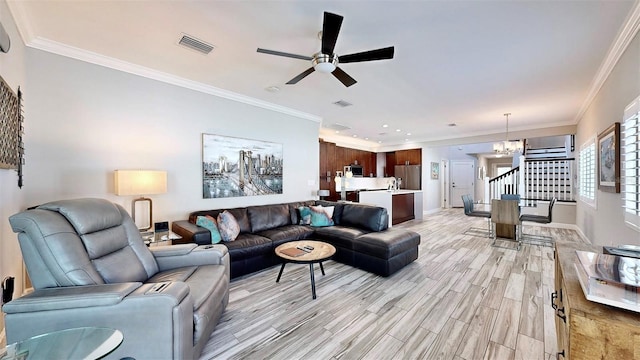 living room featuring ceiling fan with notable chandelier, ornamental molding, a wall mounted air conditioner, and light wood-type flooring