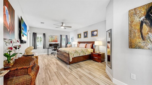 bedroom with light hardwood / wood-style flooring and ceiling fan