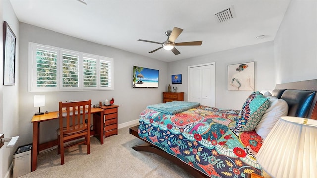 carpeted bedroom featuring ceiling fan and a closet