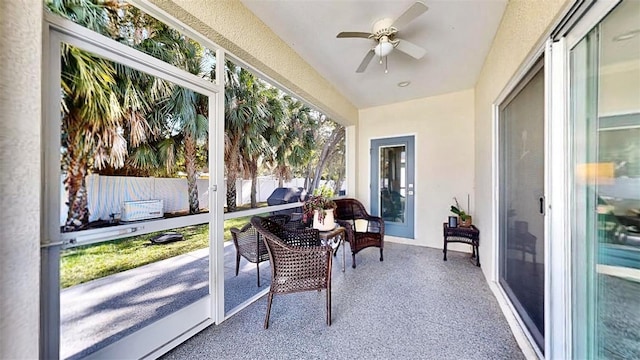 sunroom featuring ceiling fan