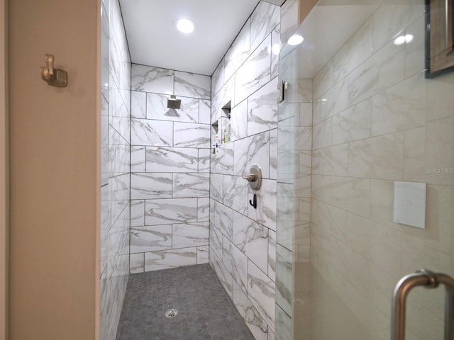 bathroom featuring a shower with door