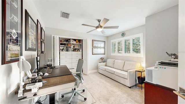 office space with ceiling fan and light carpet