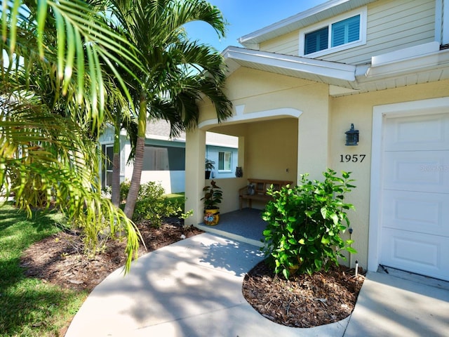 doorway to property with a garage