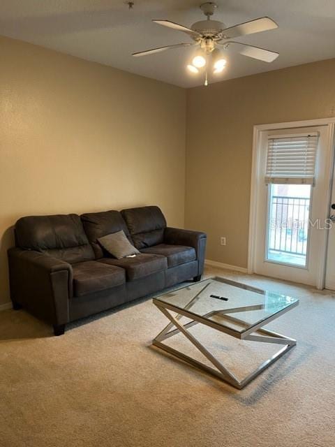 living room featuring carpet flooring and ceiling fan