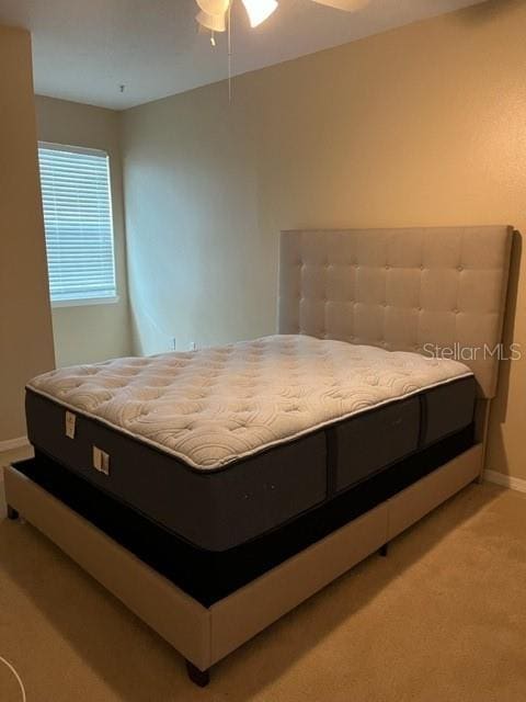 bedroom with light colored carpet and ceiling fan