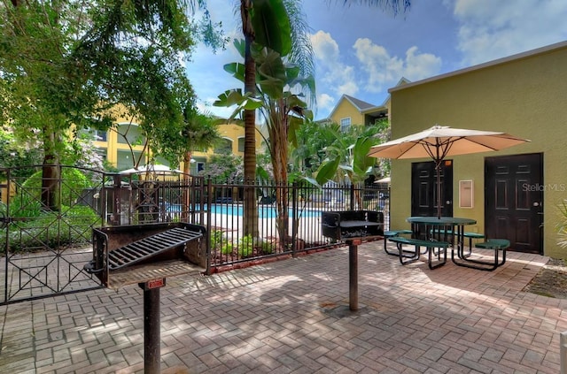 surrounding community with a pool and a patio