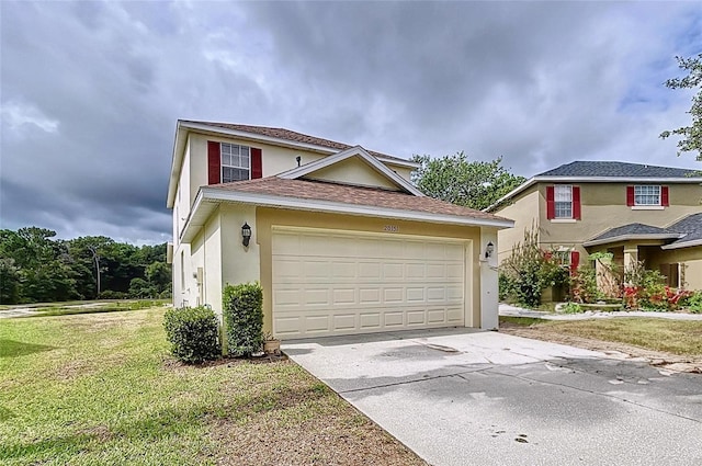 view of front of home featuring a garage and a front yard