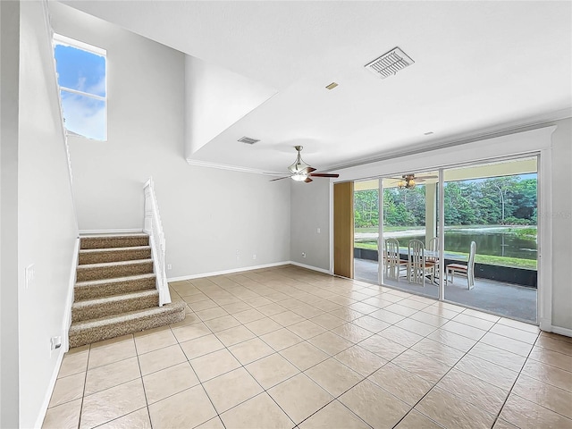 unfurnished living room with ceiling fan and light tile patterned floors