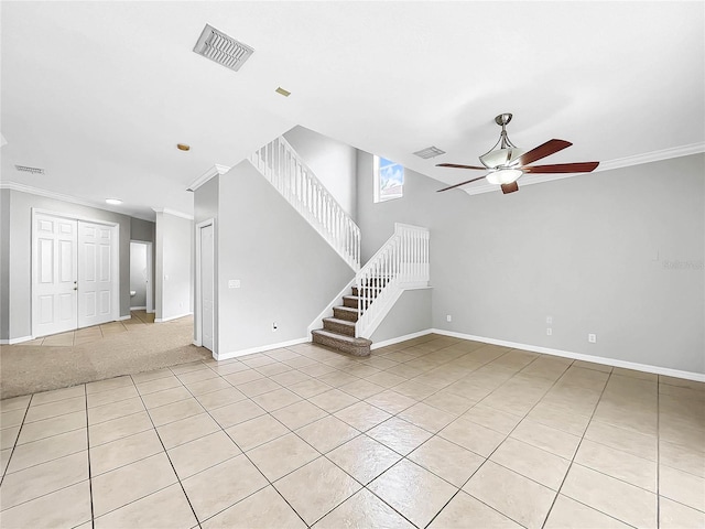 unfurnished living room featuring ceiling fan, ornamental molding, and light tile patterned floors