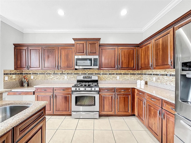 kitchen with light stone countertops, light tile patterned floors, crown molding, and appliances with stainless steel finishes