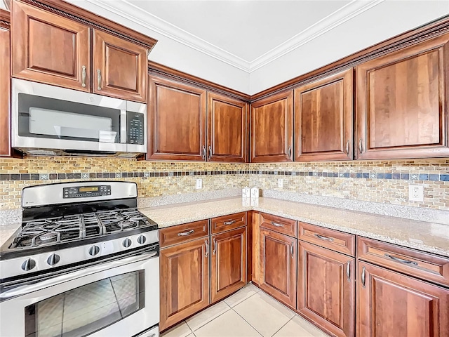 kitchen with light stone countertops, decorative backsplash, light tile patterned floors, and stainless steel appliances