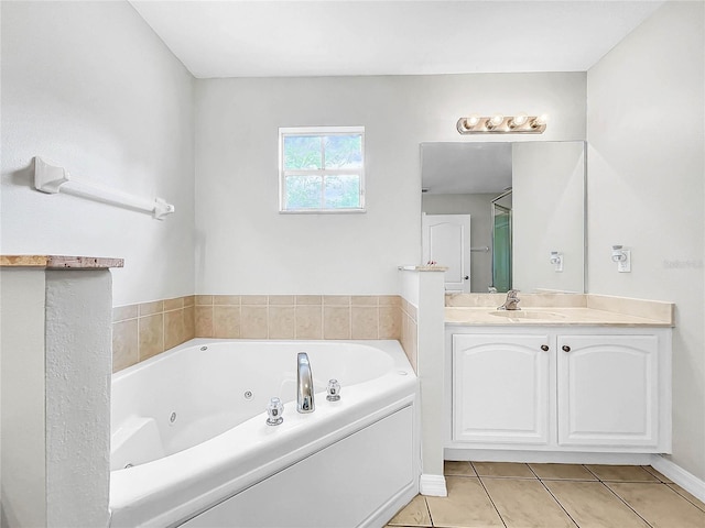 bathroom featuring tile patterned floors, a washtub, and vanity