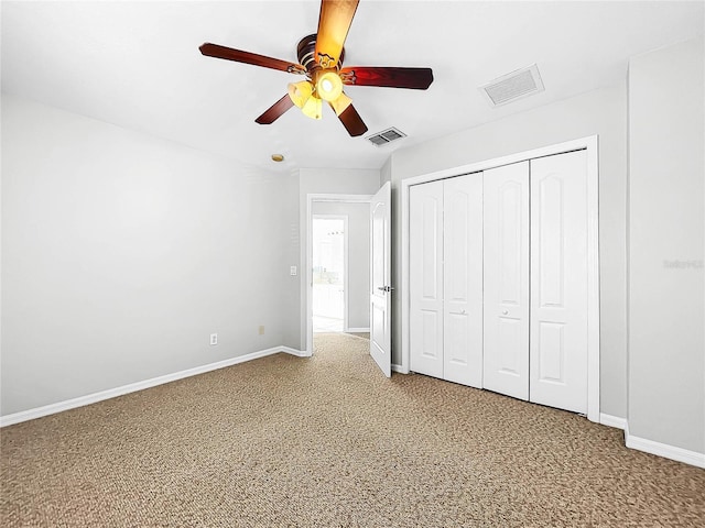 unfurnished bedroom featuring carpet floors, a closet, and ceiling fan