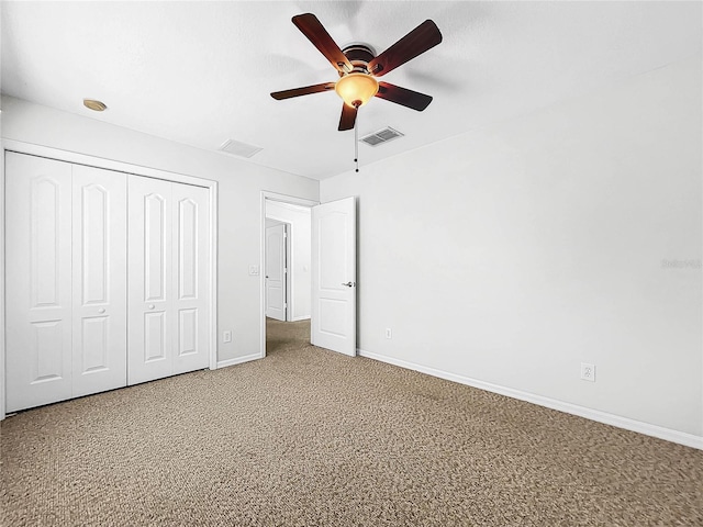 unfurnished bedroom featuring carpet, ceiling fan, and a closet