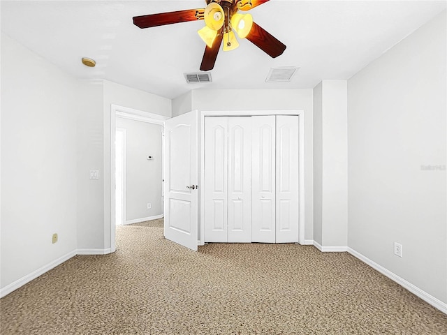 unfurnished bedroom with ceiling fan, carpet floors, and a closet