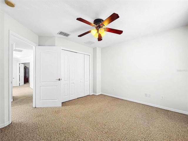 unfurnished bedroom with ceiling fan, carpet floors, and a closet