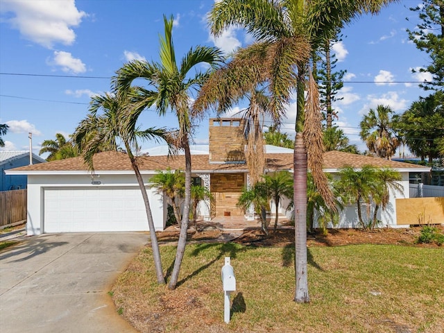 view of front of property featuring a front lawn and a garage