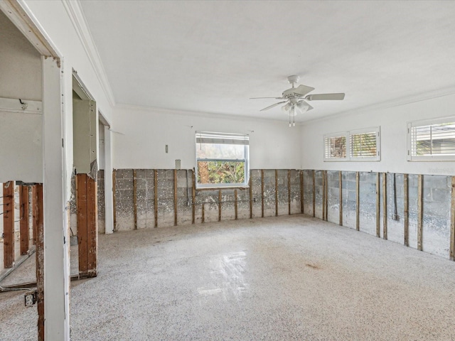 spare room featuring ceiling fan and crown molding