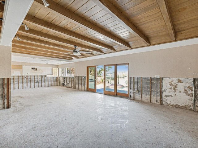 unfurnished room featuring beamed ceiling, ceiling fan, and wood ceiling