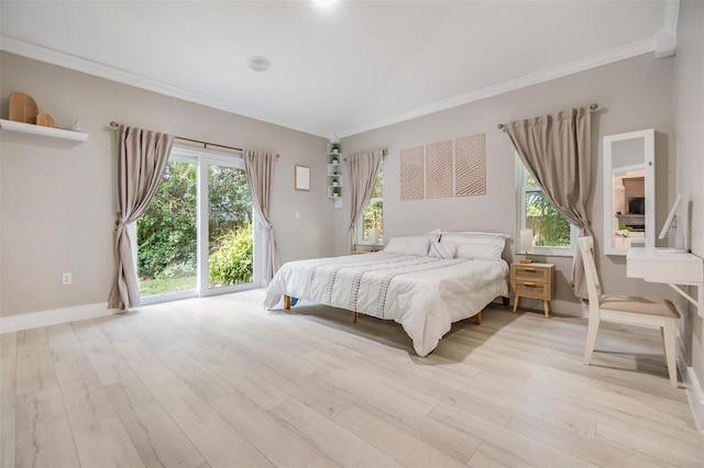 bedroom with lofted ceiling, light hardwood / wood-style floors, and ornamental molding