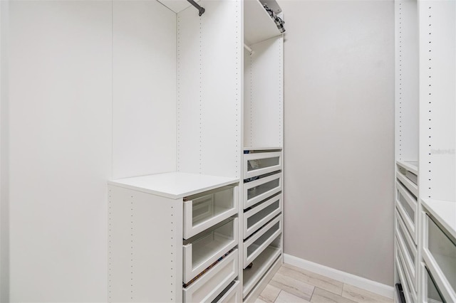 spacious closet featuring light hardwood / wood-style floors