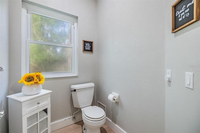 bathroom featuring a healthy amount of sunlight and toilet