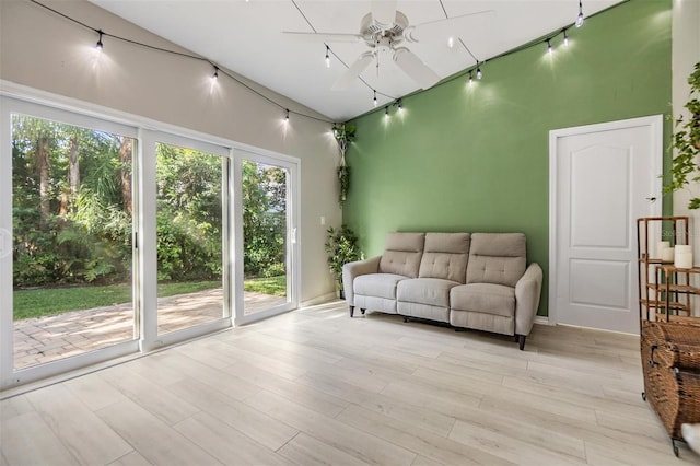 living room featuring ceiling fan, light wood-type flooring, and track lighting