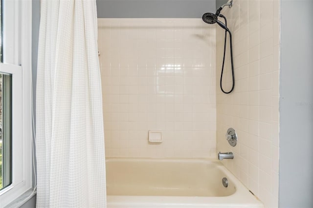 bathroom with shower / bath combination with curtain