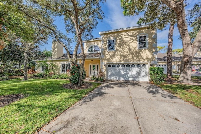 view of front property with a front yard and a garage