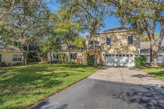 view of front of property featuring a front yard and a garage