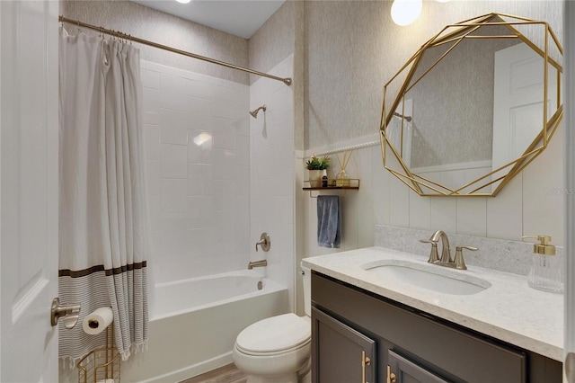 full bathroom featuring toilet, vanity, and shower / tub combo with curtain