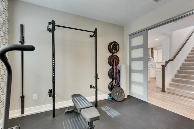 exercise room featuring a textured ceiling