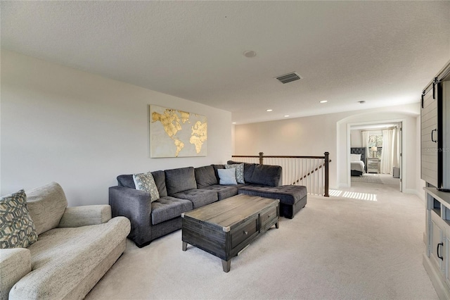 carpeted living room with a textured ceiling