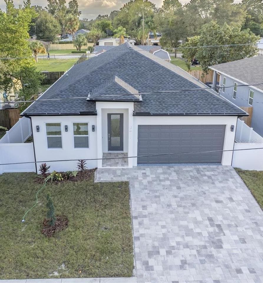 view of front of property with a garage and a front lawn