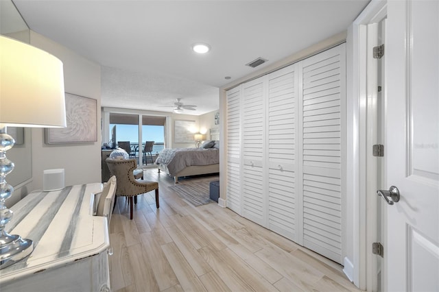 bedroom with a closet and light hardwood / wood-style flooring