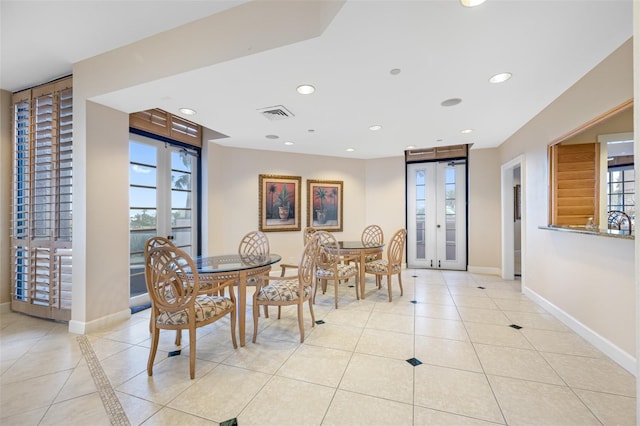 dining space featuring light tile patterned floors and french doors