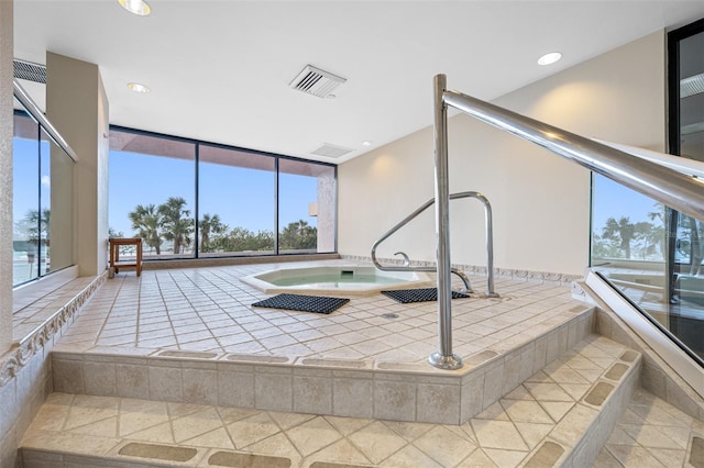 view of swimming pool with an indoor hot tub