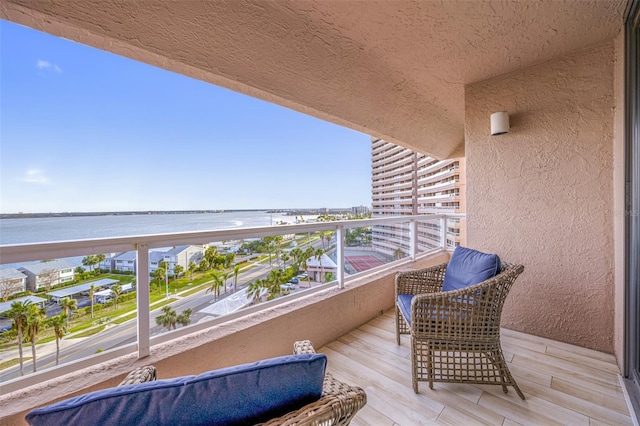 balcony featuring a water view