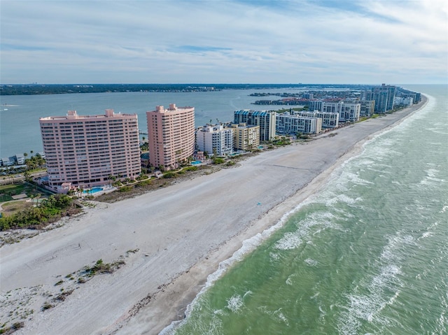 birds eye view of property featuring a beach view and a water view