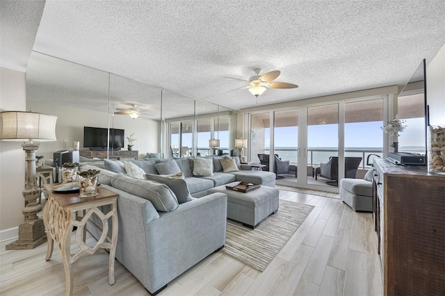 living room featuring ceiling fan and light hardwood / wood-style flooring