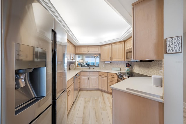 kitchen featuring light brown cabinets, sink, stainless steel appliances, tasteful backsplash, and light hardwood / wood-style flooring