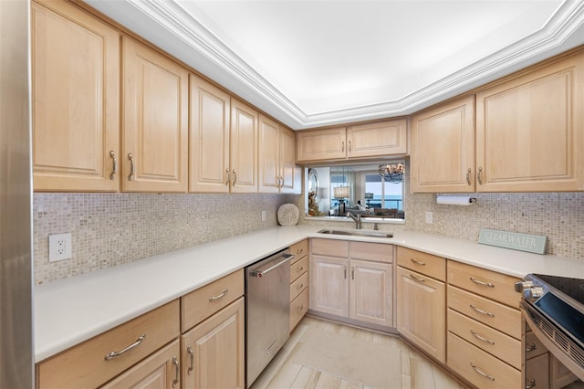 kitchen with decorative backsplash, appliances with stainless steel finishes, light brown cabinetry, and sink