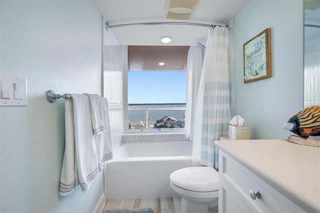 full bathroom featuring shower / bath combination with curtain, vanity, and toilet