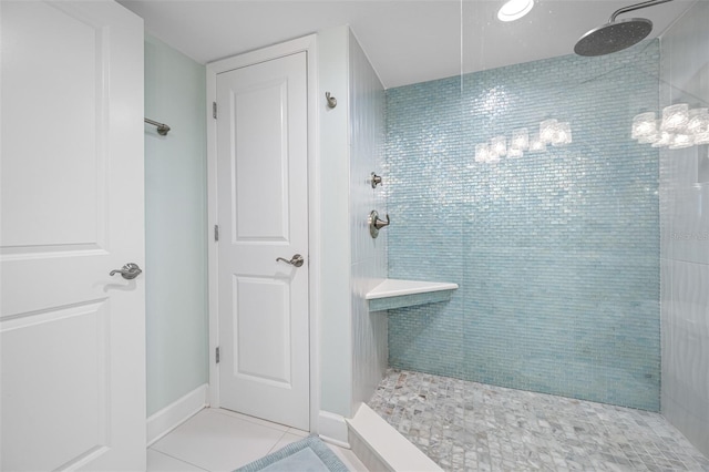 bathroom with tile patterned flooring and tiled shower