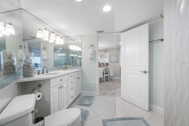 bathroom featuring tile patterned floors, vanity, and toilet